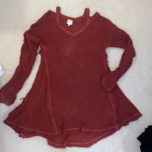 Fall sweater with raw him and shoulder cut out detail